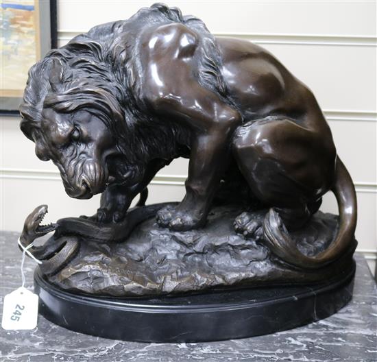 After Barye. A bronze lion and snake, signed height 34cm